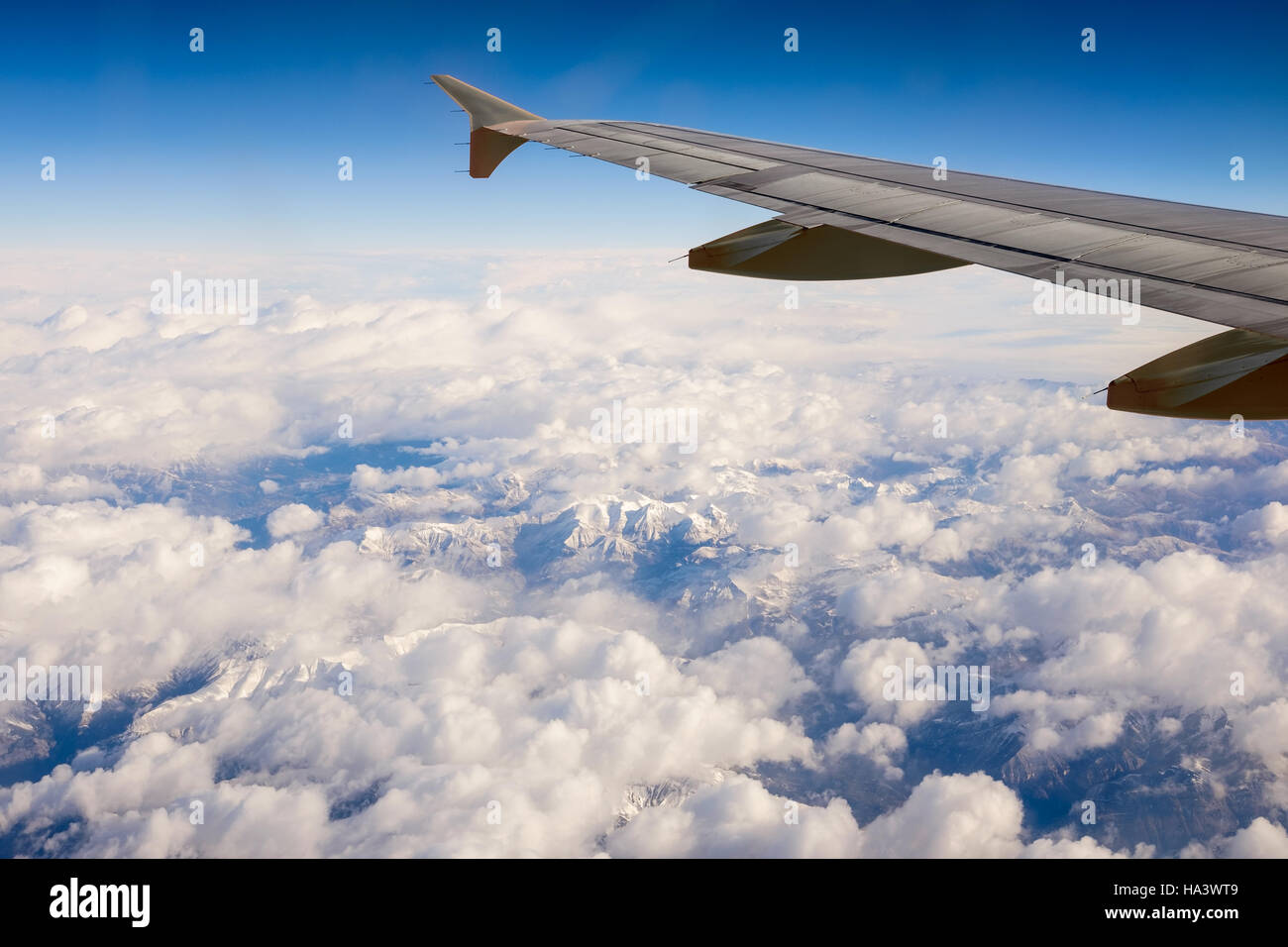 Der Blick aus einem Flugzeugfenster während des Fluges über die schneebedeckten Gipfel der französischen Alpen. Stockfoto