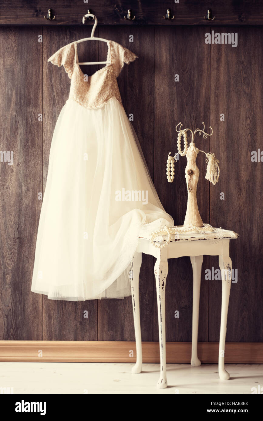 Perlenkette auf Schmuck Ständer mit hübschen Kleid im Hintergrund Stockfoto