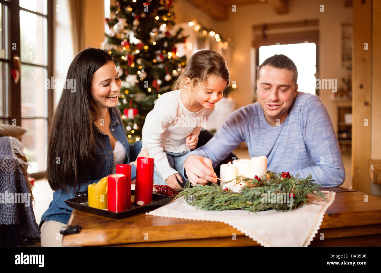 Junge Familie Anzünden Von Kerzen Am Adventskranz. Weihnachtsbaum  Stockfotografie - Alamy