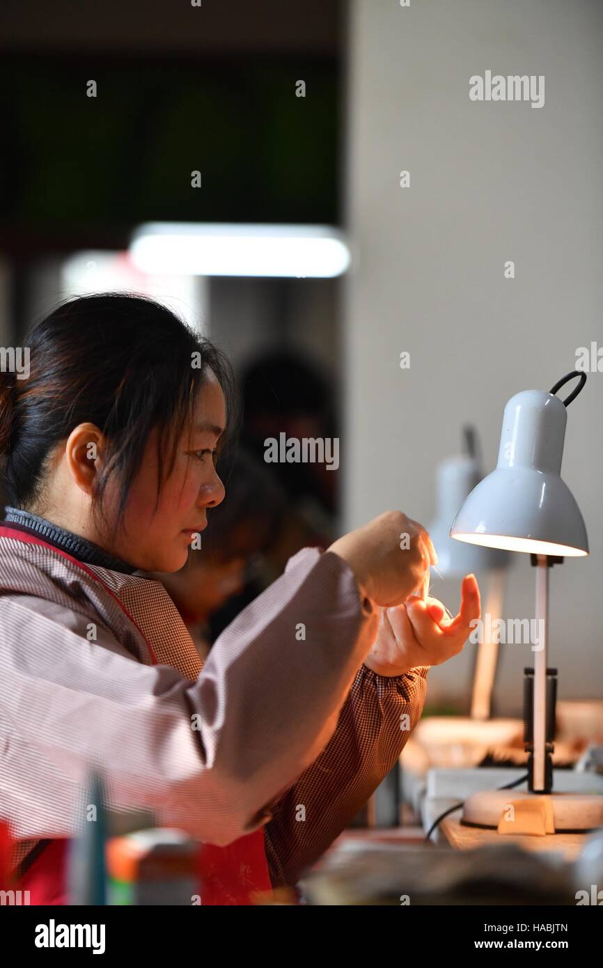 Der chinesischen Nanchang, Jiangxi Provinz. 29. November 2016. Eine Frau arbeitet in einem Schreiben Pinsel Herstellung Workshop in Wengang Stadt Jinxian County, Osten Chinas Jiangxi Provinz, 29. November 2016. Lokale Regierung zufolge hat die Ausgabe des Schreibens Bürsten 700 Millionen im Jahr 2015 erreicht. © Hu Chenhuan/Xinhua/Alamy Live-Nachrichten Stockfoto