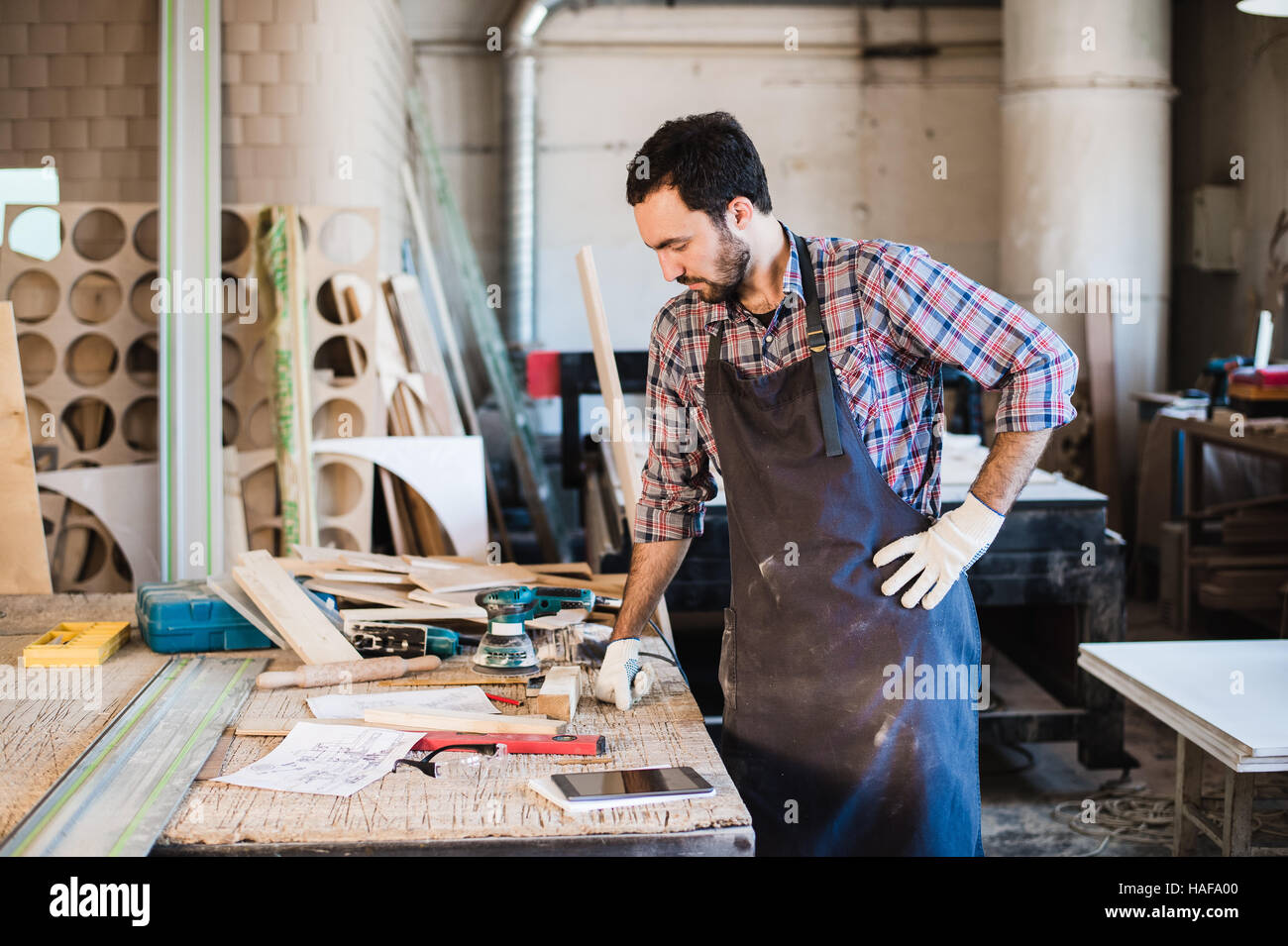 Tischler arbeiten, sorgfältiger Blick auf die Pläne Stockfoto