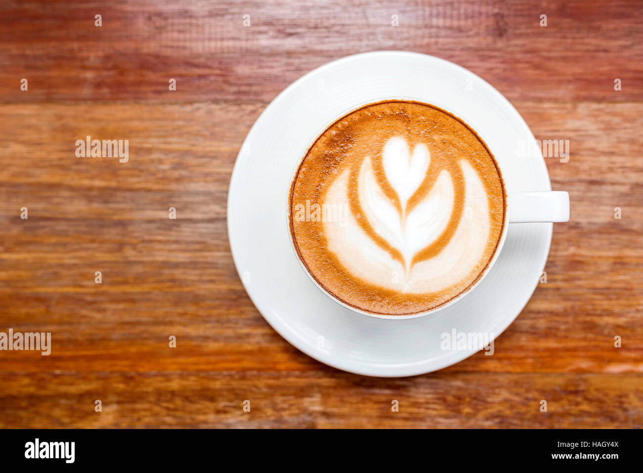 Tasse heißen Latte Art Kaffee auf Holztisch, Ansicht von oben. Stockfoto