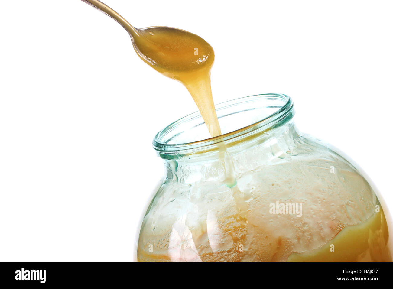 Honig-Glas und Löffel Stockfoto