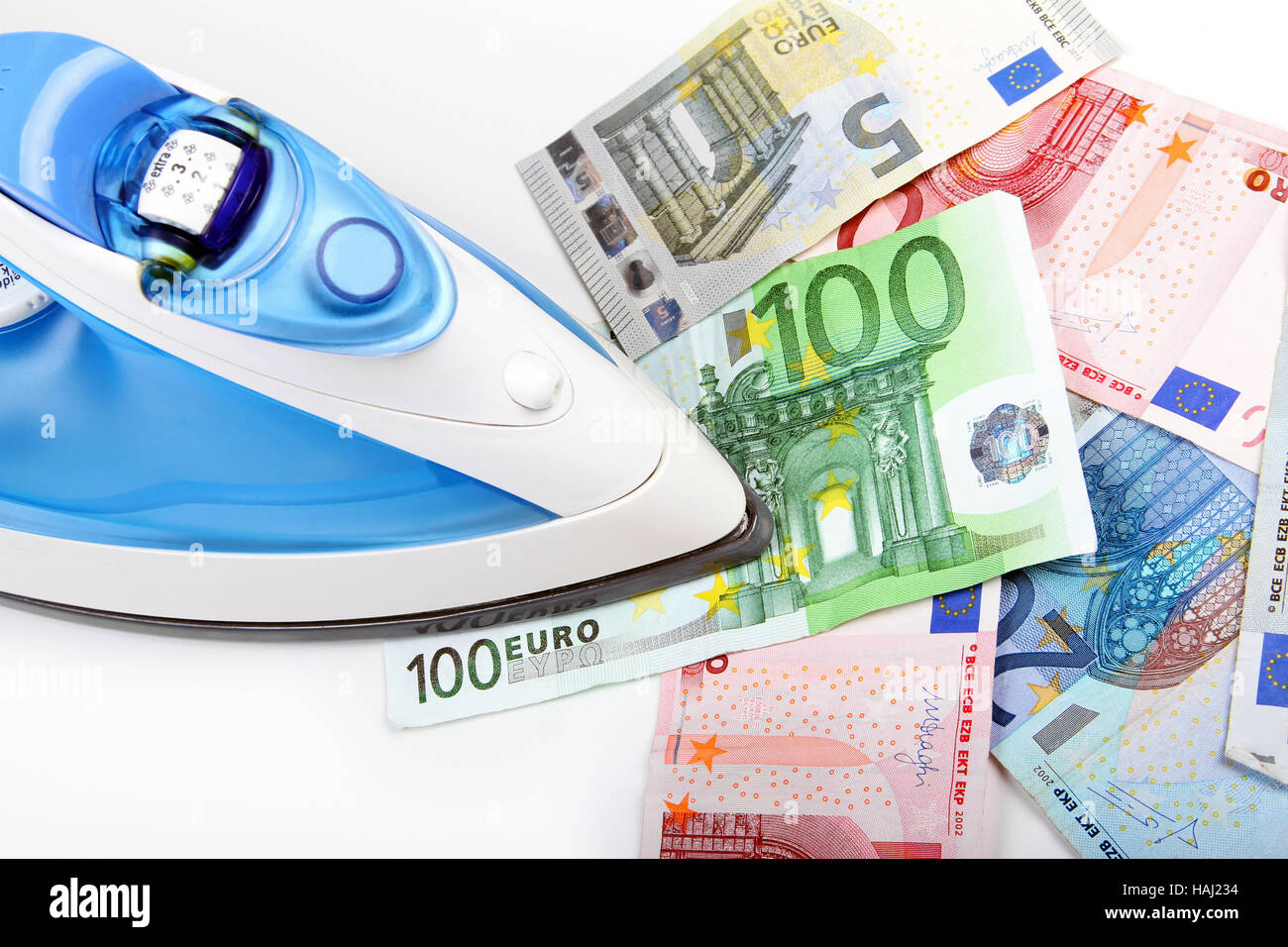 Bügeleisen / Euro-Geld Stockfoto