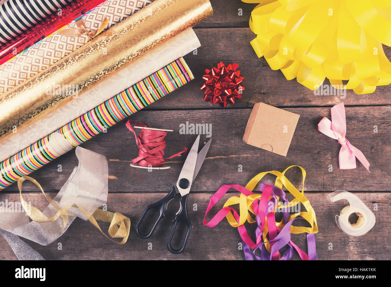 Geschenk-Verpackung-Rollen und Zubehör auf dem Tisch Stockfoto
