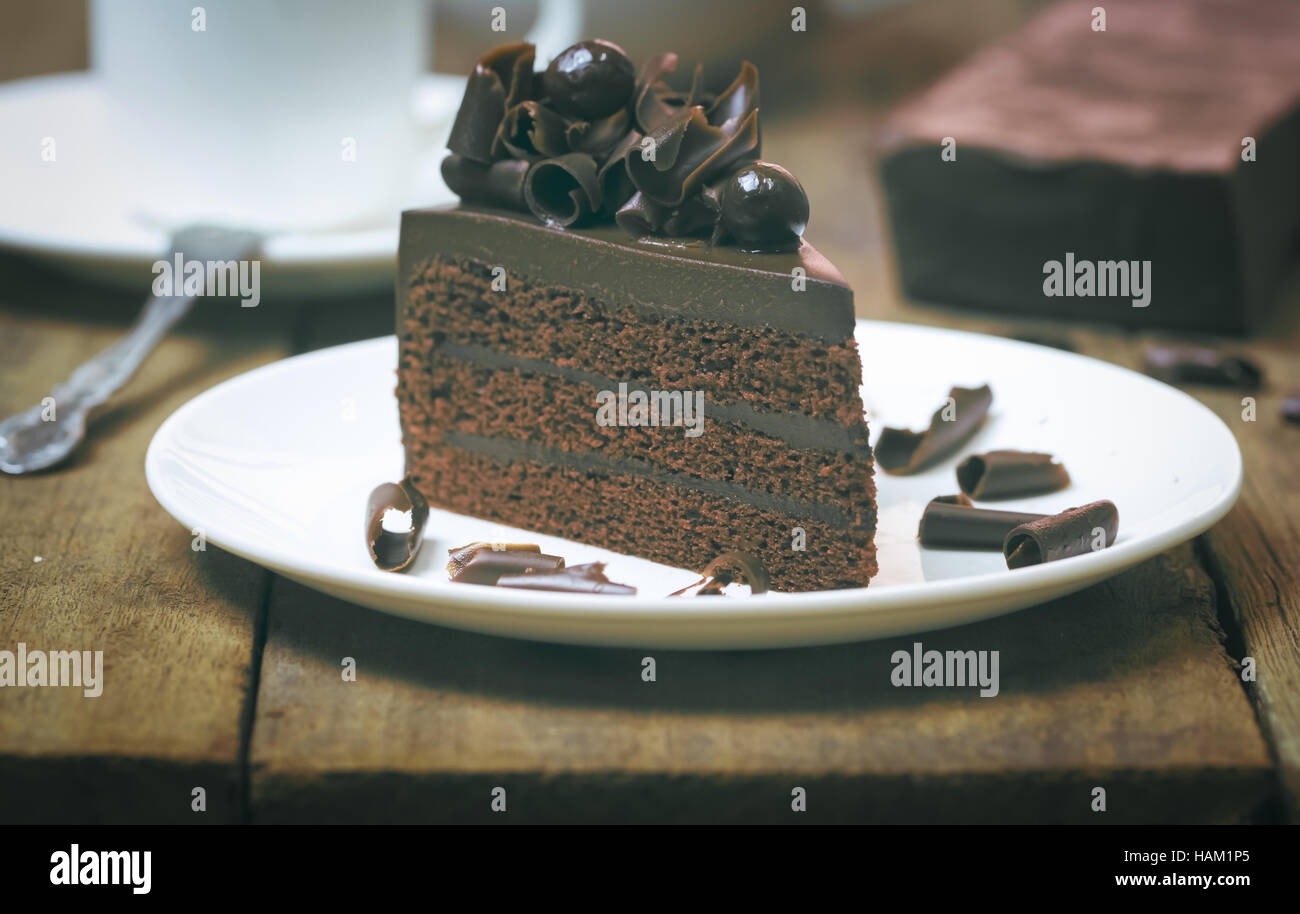 Schokoladen-Kuchen mit Schokolade Curl auf Holz Hintergrund, Richtfest Vintage Muskelaufbau Stockfoto