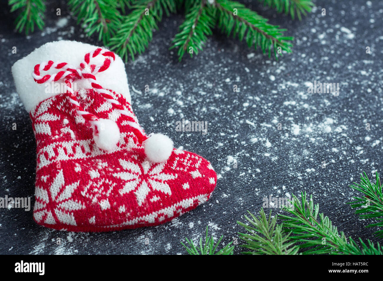 Weihnachten und Neujahr Winter Urlaub snowbound Zusammensetzung der roten Strumpf auf schwarzen Raum Hintergrund mit grünen Tannenzweigen Baum Stockfoto