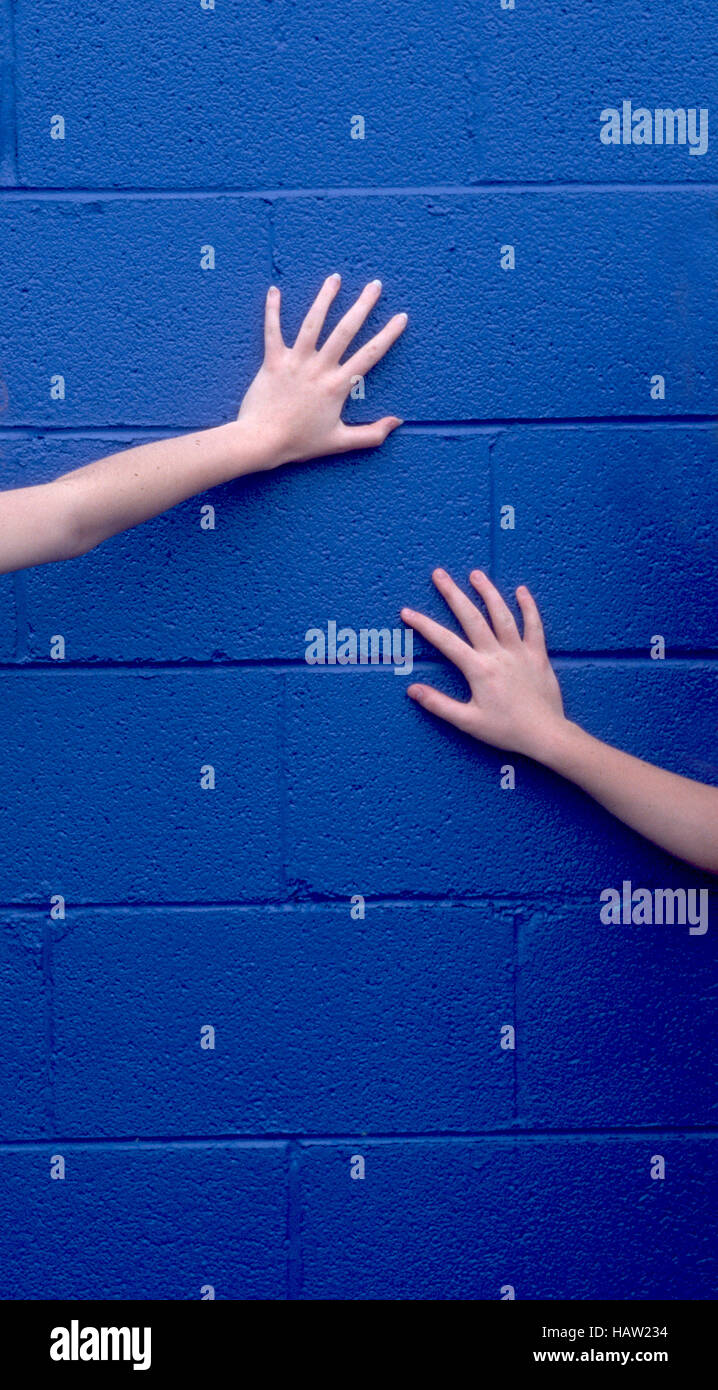 Hände auf blaue Wand Stockfoto