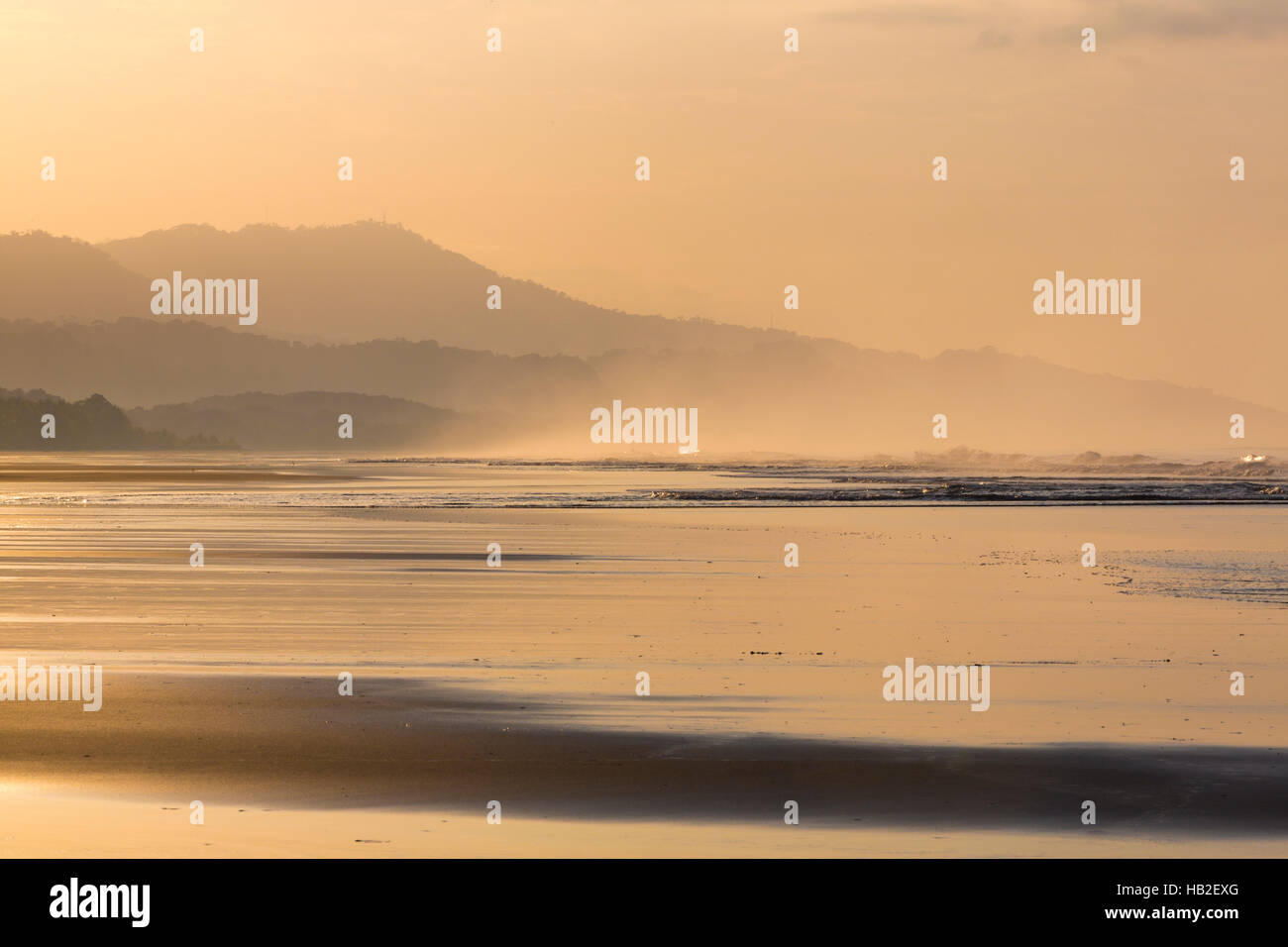 Silhouetten von zwei Menschen, die zu Fuß am Strand Stockfoto