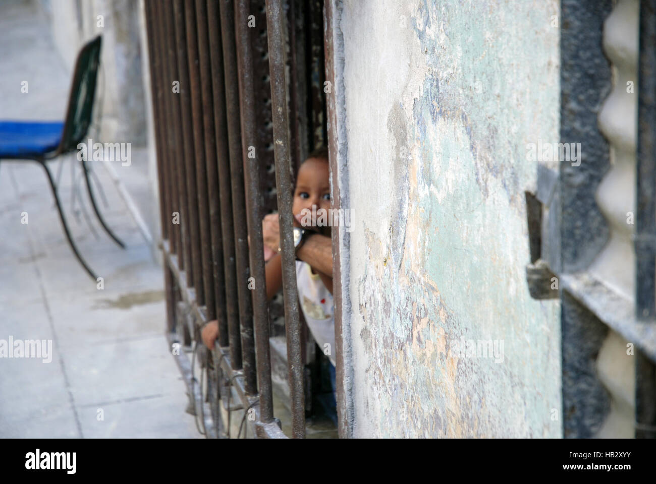 Junge Junge, aus Eisen Türrahmen, Havanna, Kuba. Stockfoto