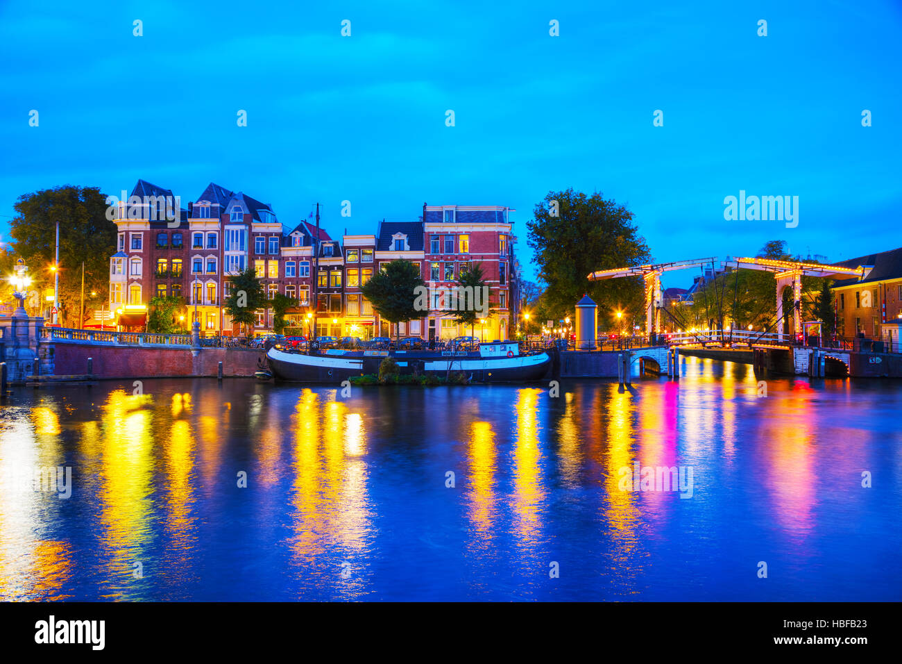 Blick auf die Stadt Amsterdam mit Kanälen und Brücken in der Nacht Stockfoto