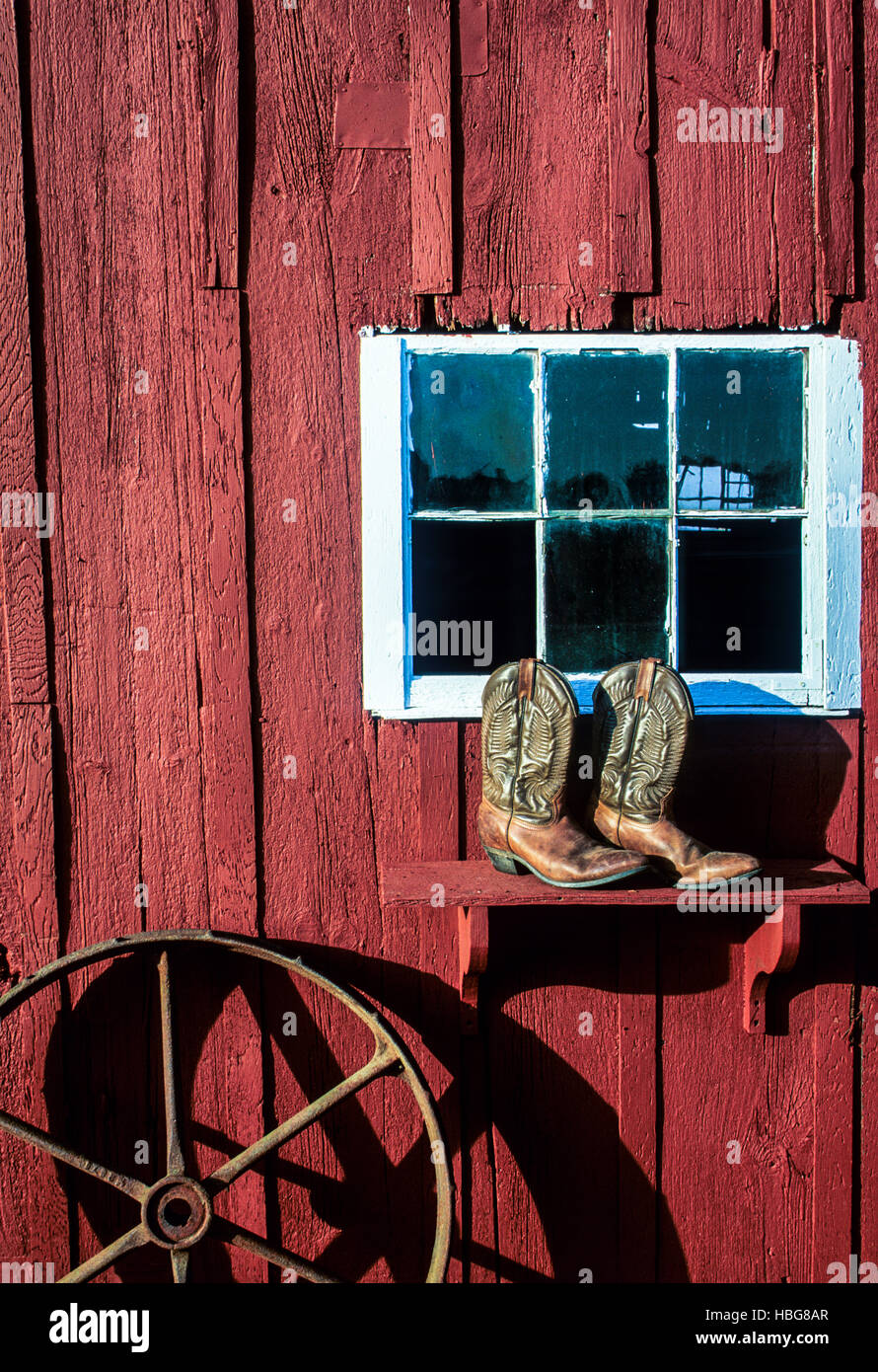 Vintage Western-Szene eines alten roten Scheunenfensters, Cowboystiefel, Wagenrad abstrakt, Mercer County, New Jersey, USA, Landwirtschaft Antiquitäten Bauernhof pt Stockfoto