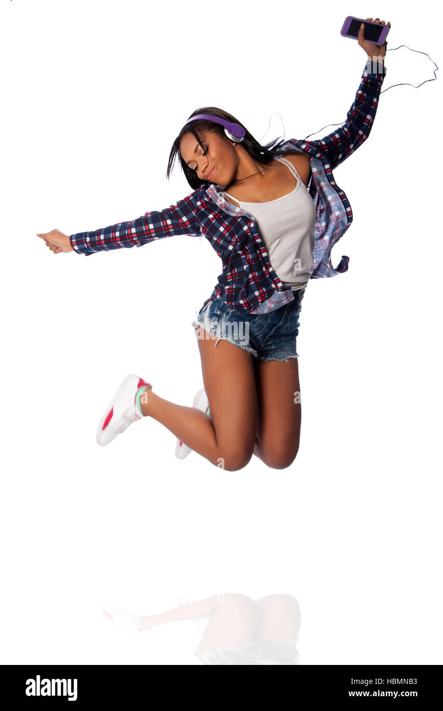 Springen, glücklich tanzen Musik anhören Stockfoto