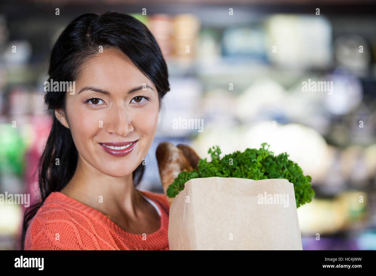 Frau hält Lebensmittel in Papiertüte Stockfoto
