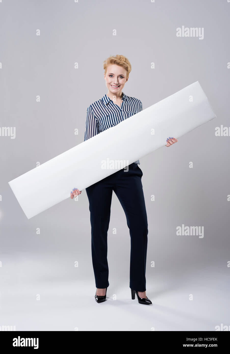 Frau, die trägt ein langes weißes Plakat Stockfoto