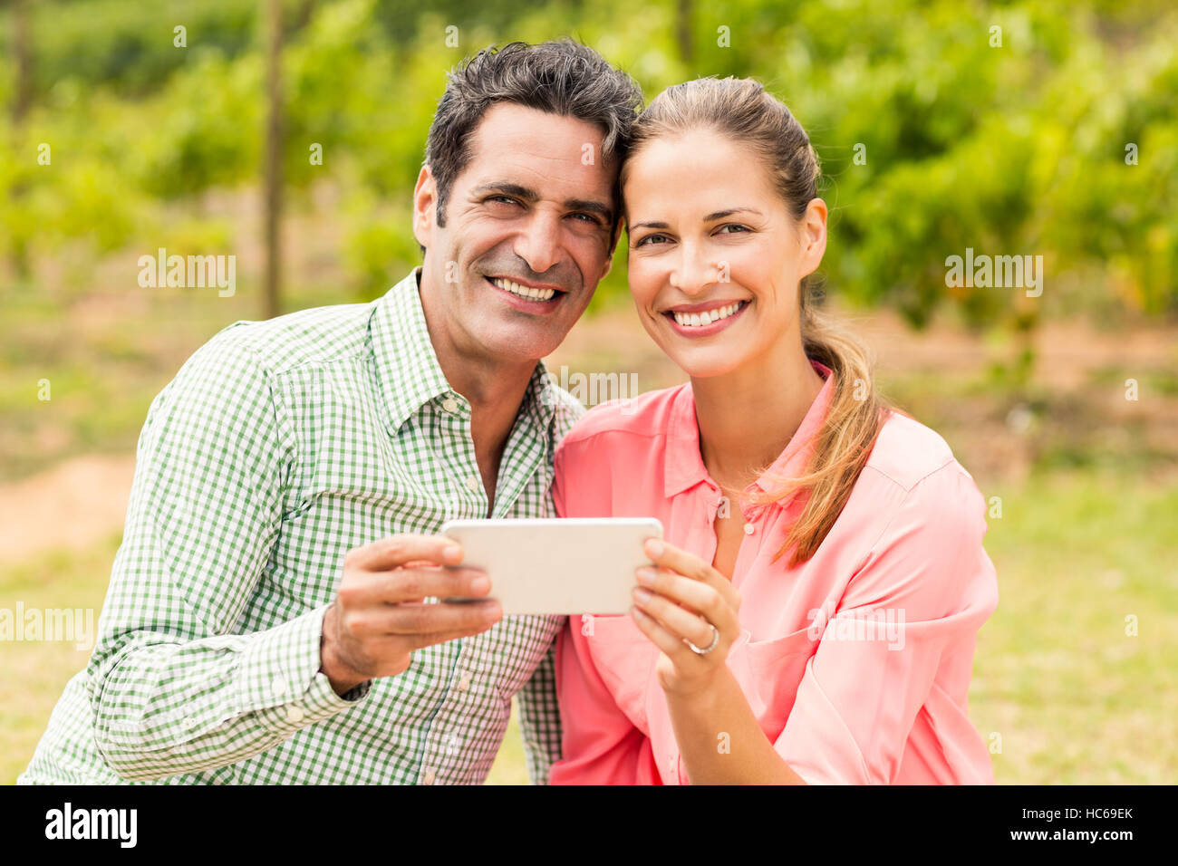 Porträt des glücklichen Paares halten Handys Stockfoto