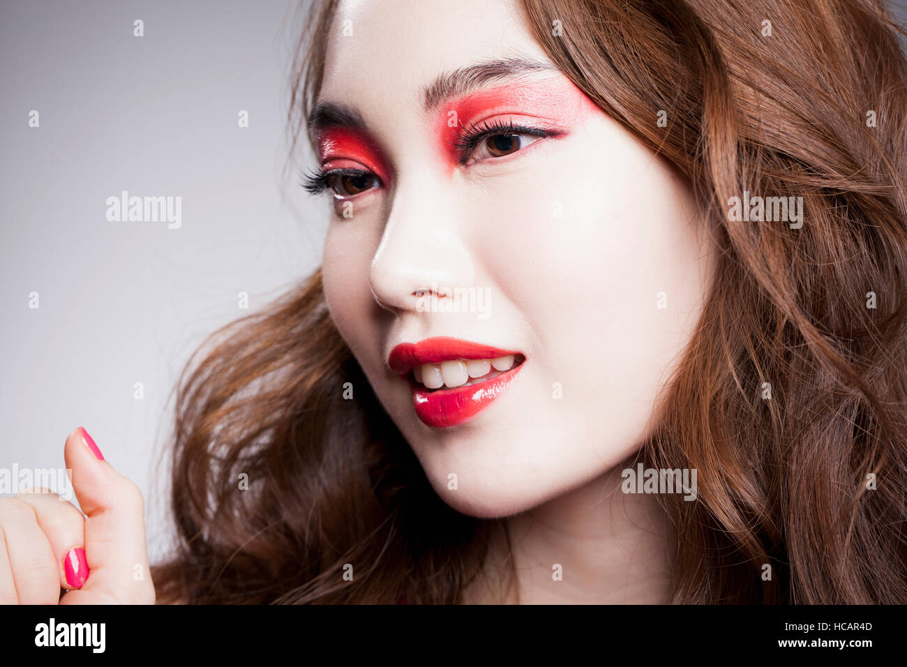Porträt der jungen Frau mit roten Augen und rote Lippen Stockfoto