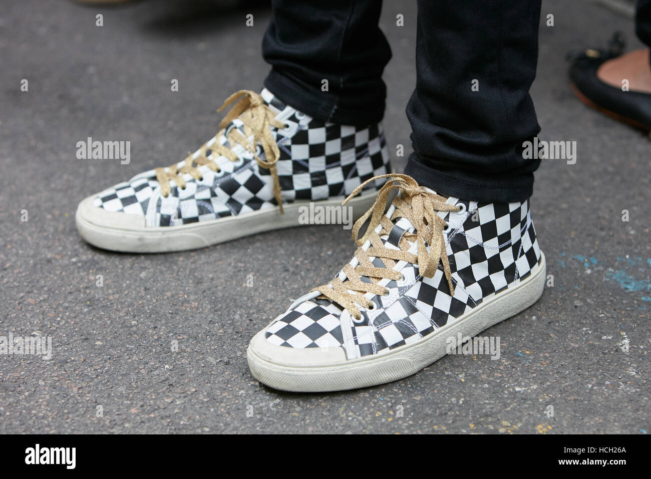 Mann mit karierten schwarze und weiße Schuhe mit goldenen Schnürsenkel vor Max Mara Fashion Show in Mailand Fashion Week Streetstyle. Stockfoto