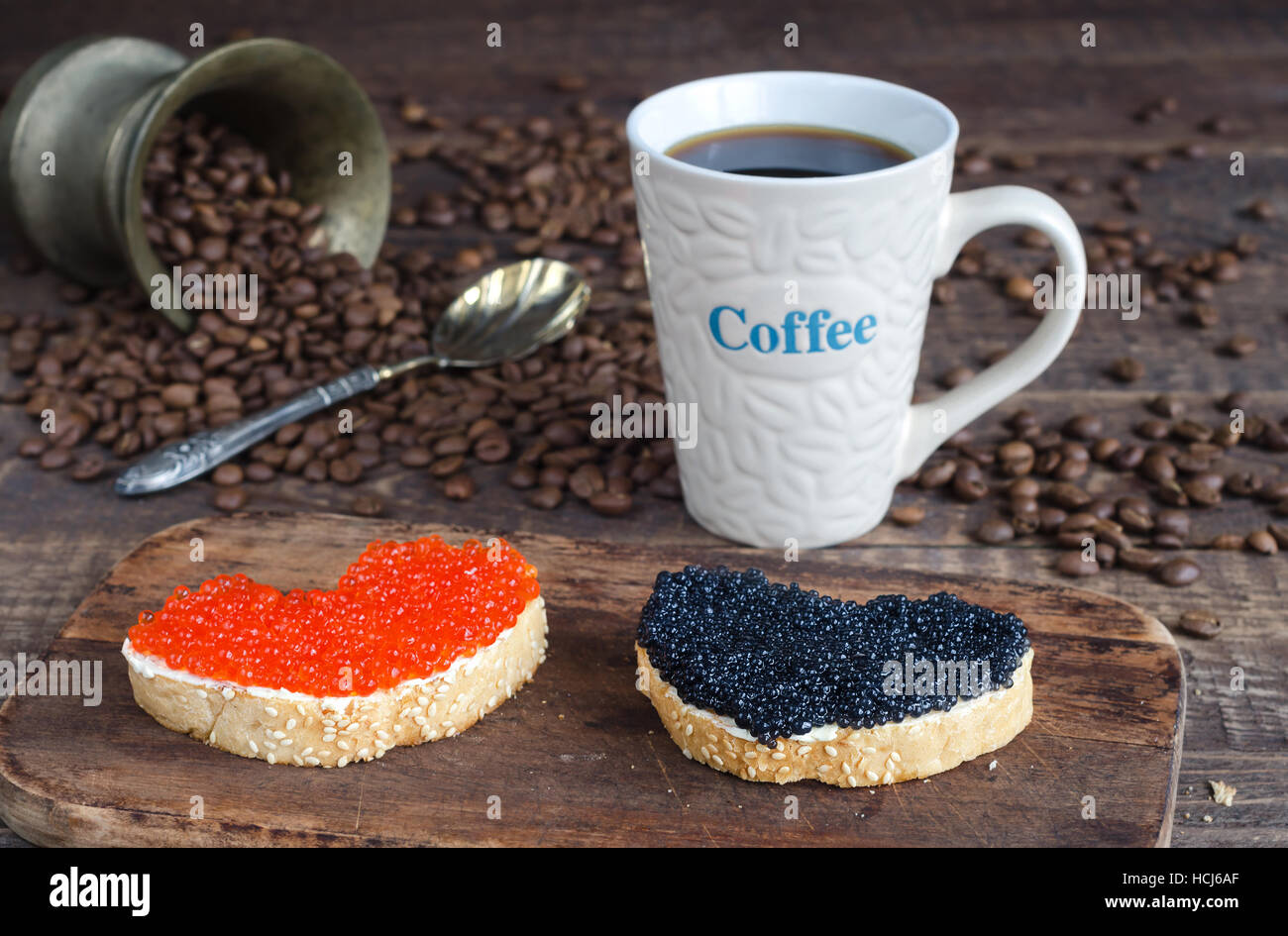 Sandwiches in der Form des Herzens und der Kaffee auf der Holzoberfläche. Stockfoto
