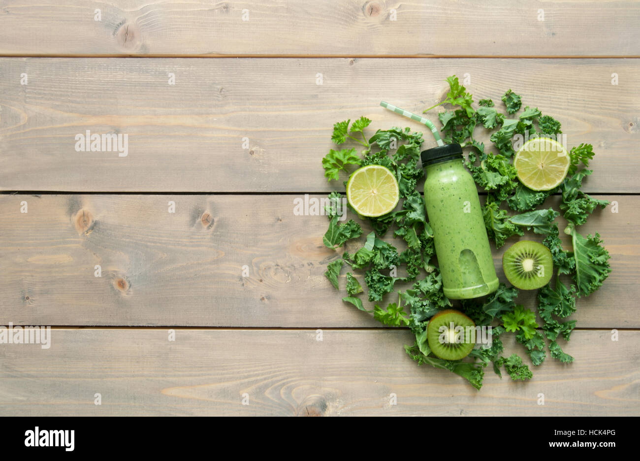 Grüner Smoothie Getränke in einer Flasche über einen Holztisch mit Zutaten Stockfoto