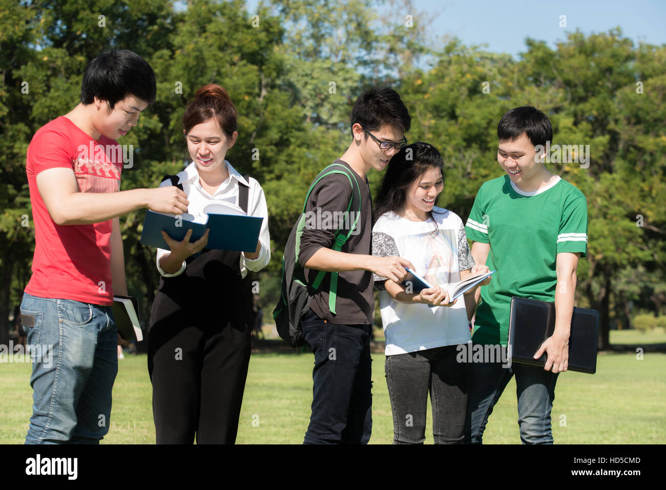 Asiatische junge attraktive lächelnd Studentengruppe gekleidet casual stehen am Park im Freien auf dem Campus der Universität. Student der Universität. Stockfoto