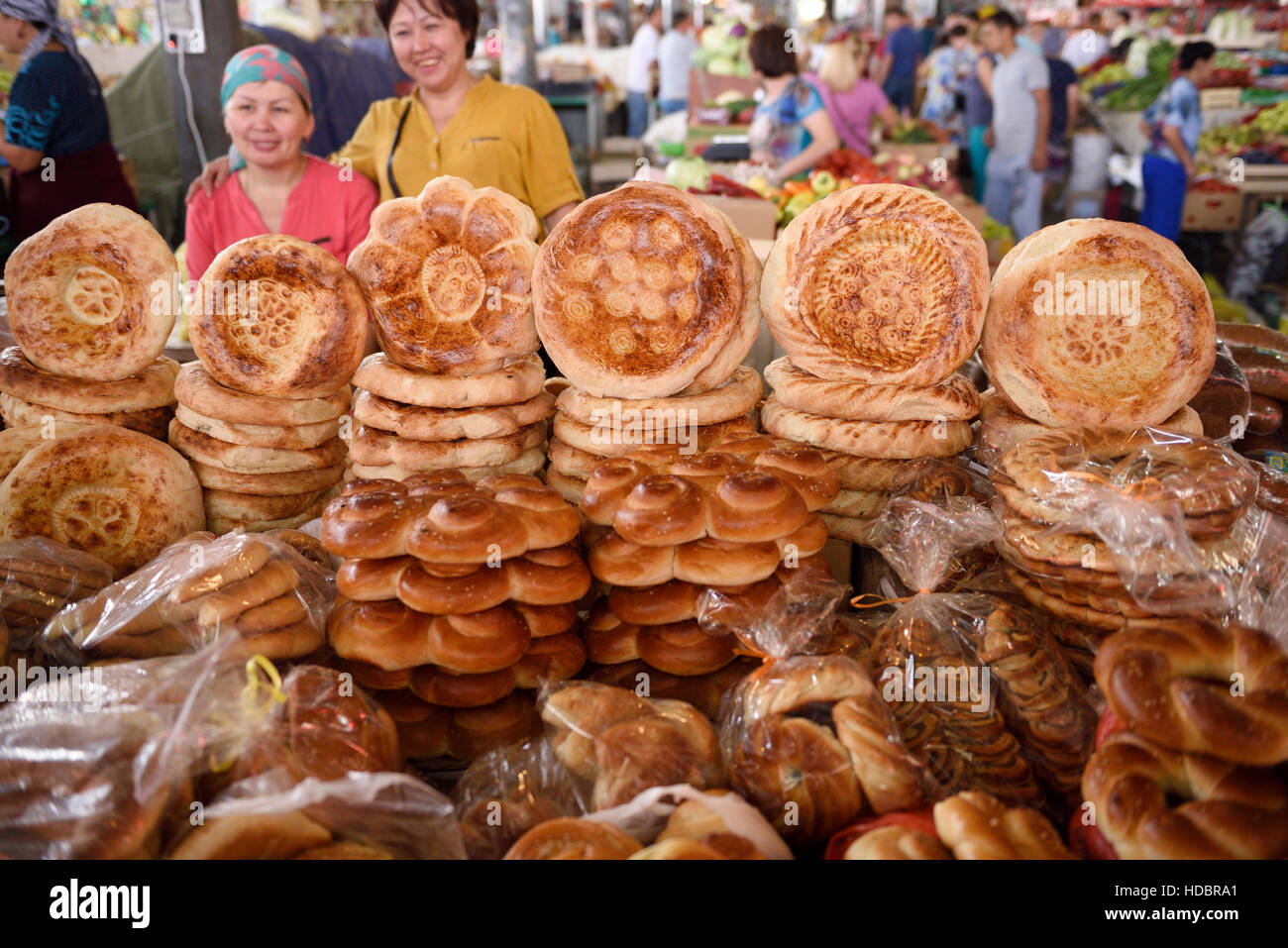Ladenbesitzer in Schymkent Central Market neben Tisch Kazkh Tandyr Nan Brot Kasachstan Stockfoto