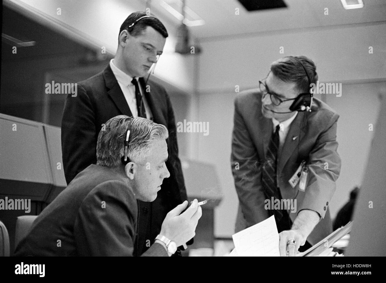 NASA Flug Regisseure John Hedge (L-R), Glynn Lunney und James Beach während des Gemini-Titan 3 Starts am Johnson Space Center Mission Control Center 23. März 1965 in Houston, Texas. Stockfoto