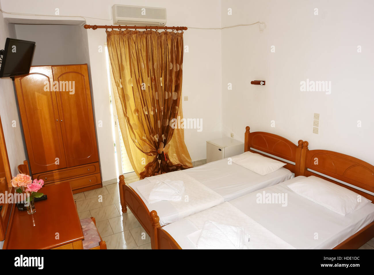 Vrahos, Griechenland, 10. Mai 2013: Fragmente innen Schlafzimmer mit großem Bett und einem gelben Vorhang. Stockfoto