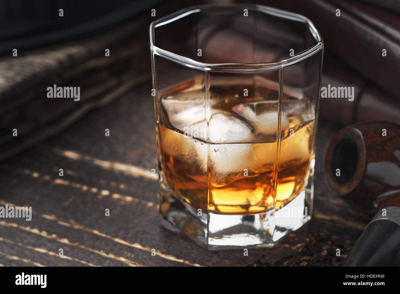 Whisky mit Eis und Pfeife auf dem Holztisch Stockfoto