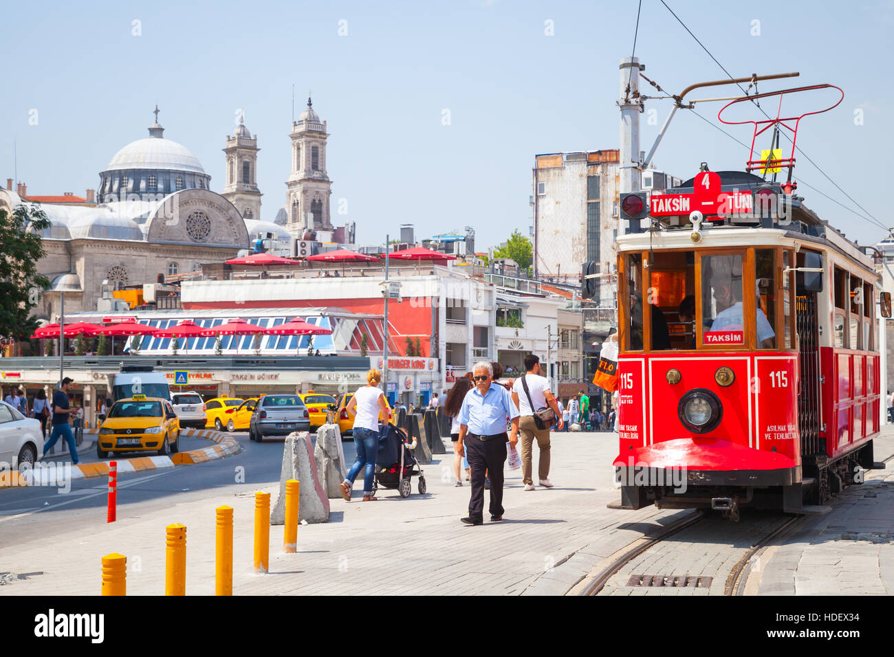 Istanbul, Türkei - 1. Juli 2016: Vintage rote Straßenbahn fährt am Taksim-Platz in Istanbul, gewöhnliche Menschen in der Nähe zu Fuß. Beliebte öffentliche Verkehrsmittel Stockfoto