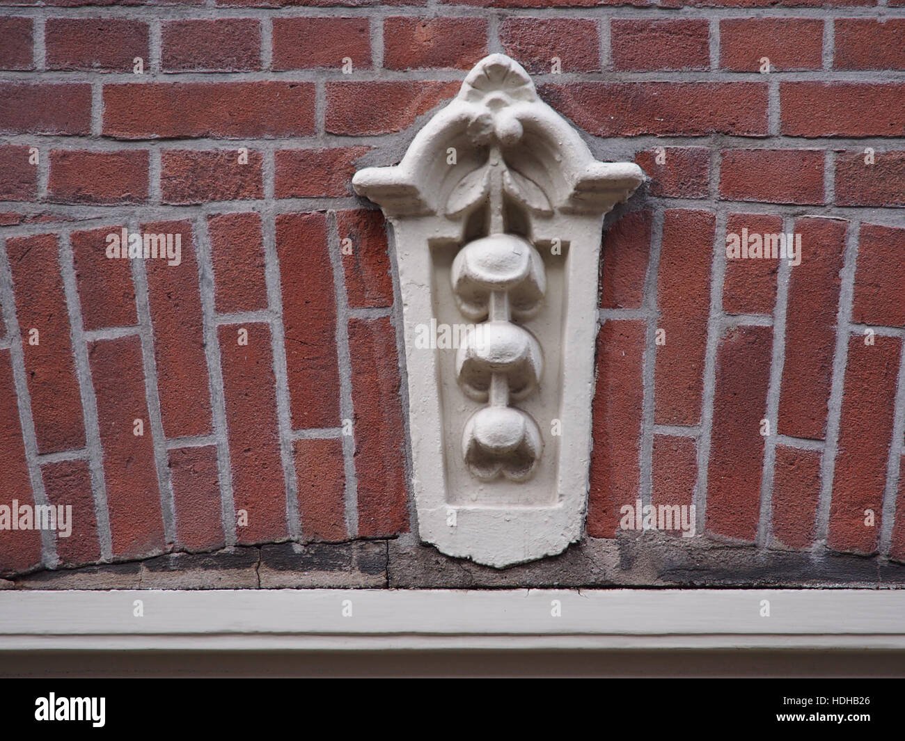 Eine Fotografie des Schließsteins in der Tweede Jan Steenstraat 83 in den Niederlanden. Dieses architektonische Merkmal ist Teil der historischen Fassade des Gebäudes, typisch für die niederländische Stadtarchitektur des 19. Jahrhunderts. Stockfoto