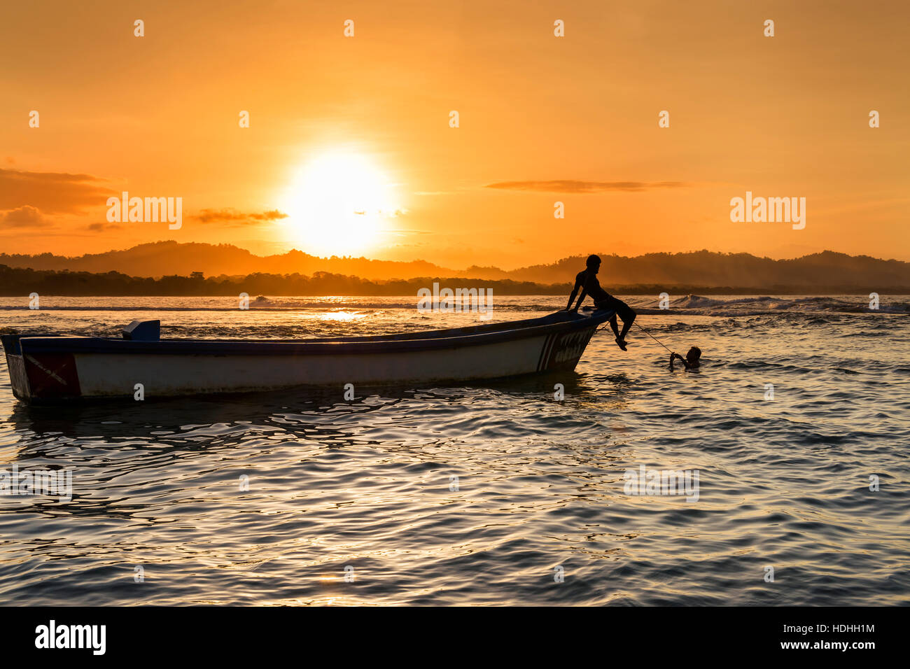 Silhouette eines Bootes und Menschen an einem Strand in Puerto Viejo de Talamanca, Costa Rica, Mittelamerika Stockfoto
