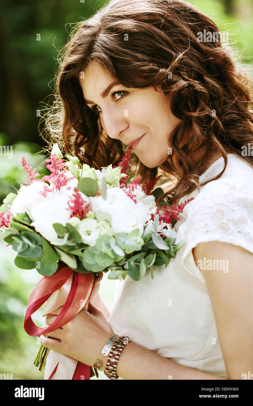Lächelnde Braut mit Hochzeit Blumen Nahaufnahme Stockfoto