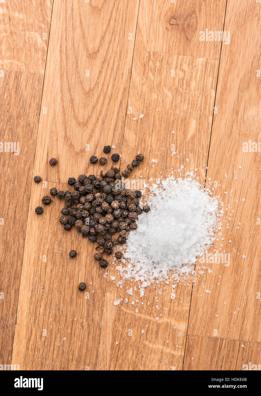 Salz und schwarzem Pfeffer auf einem Holztisch. Essen-Hintergrund mit Textfreiraum. Stockfoto