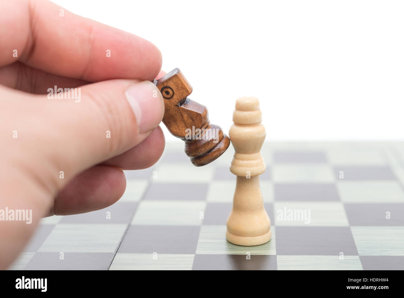 schwarzen Schachspieler knockt den weißen König mit seinen Springer Stockfoto