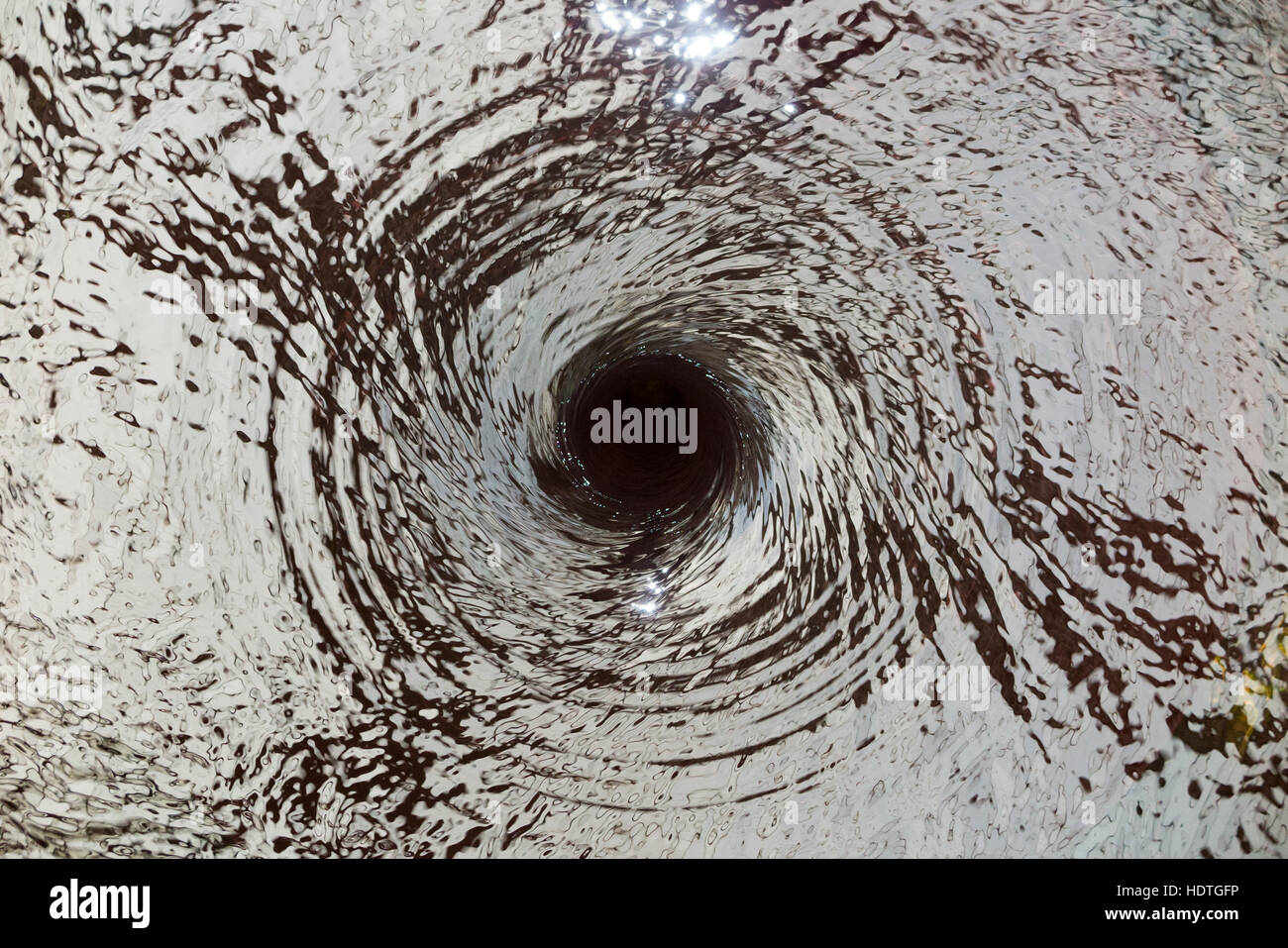 Wasser Vortex / ablassen / Entwässerung entfernt/Flüssigkeit Spirale nach unten ein Loch (wie ein Dübelloch / Abfluss) in einem unsichtbaren Wasserspiel. Stockfoto