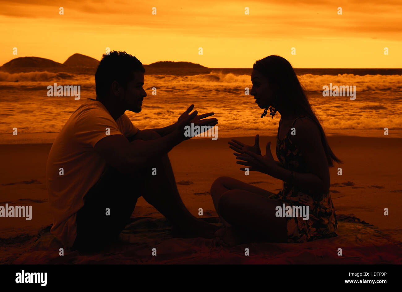 Liebespaar mit Beziehungsschwierigkeiten im Freien am Strand bei Sonnenuntergang Stockfoto
