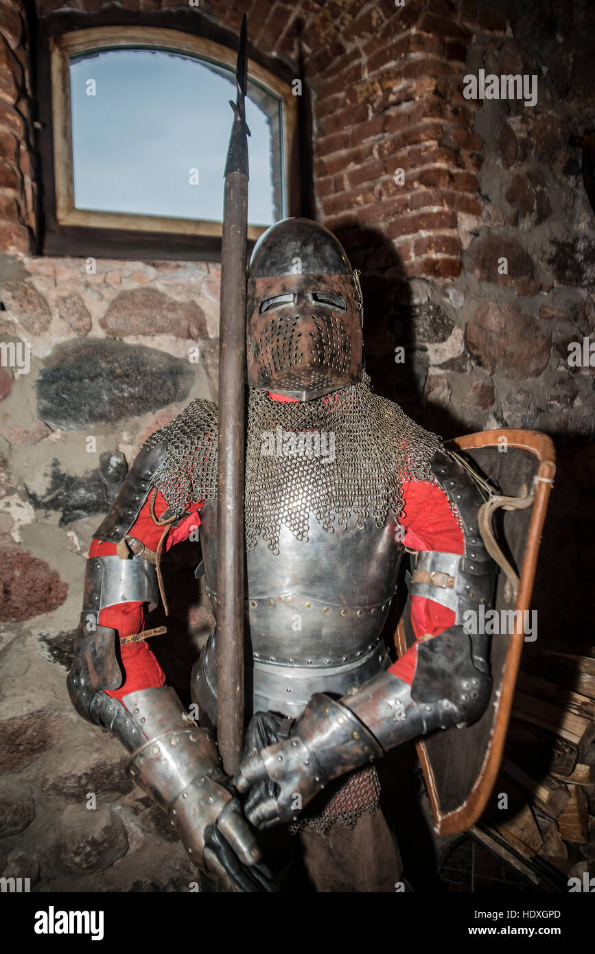 Mittelalterlicher Krieger Soldat Metall Schutzkleidung tragen. Anzug der Ritter Rüstung stehen im Tample Interieur mit Fenster im Ziegelmauer Stockfoto