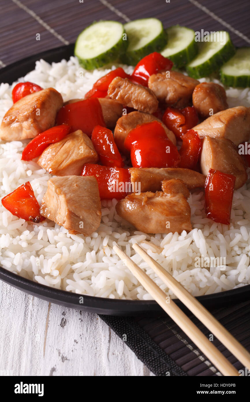 Asiatische Küche: Reis mit Huhn und Gemüse close-up, vertikale Stockfoto