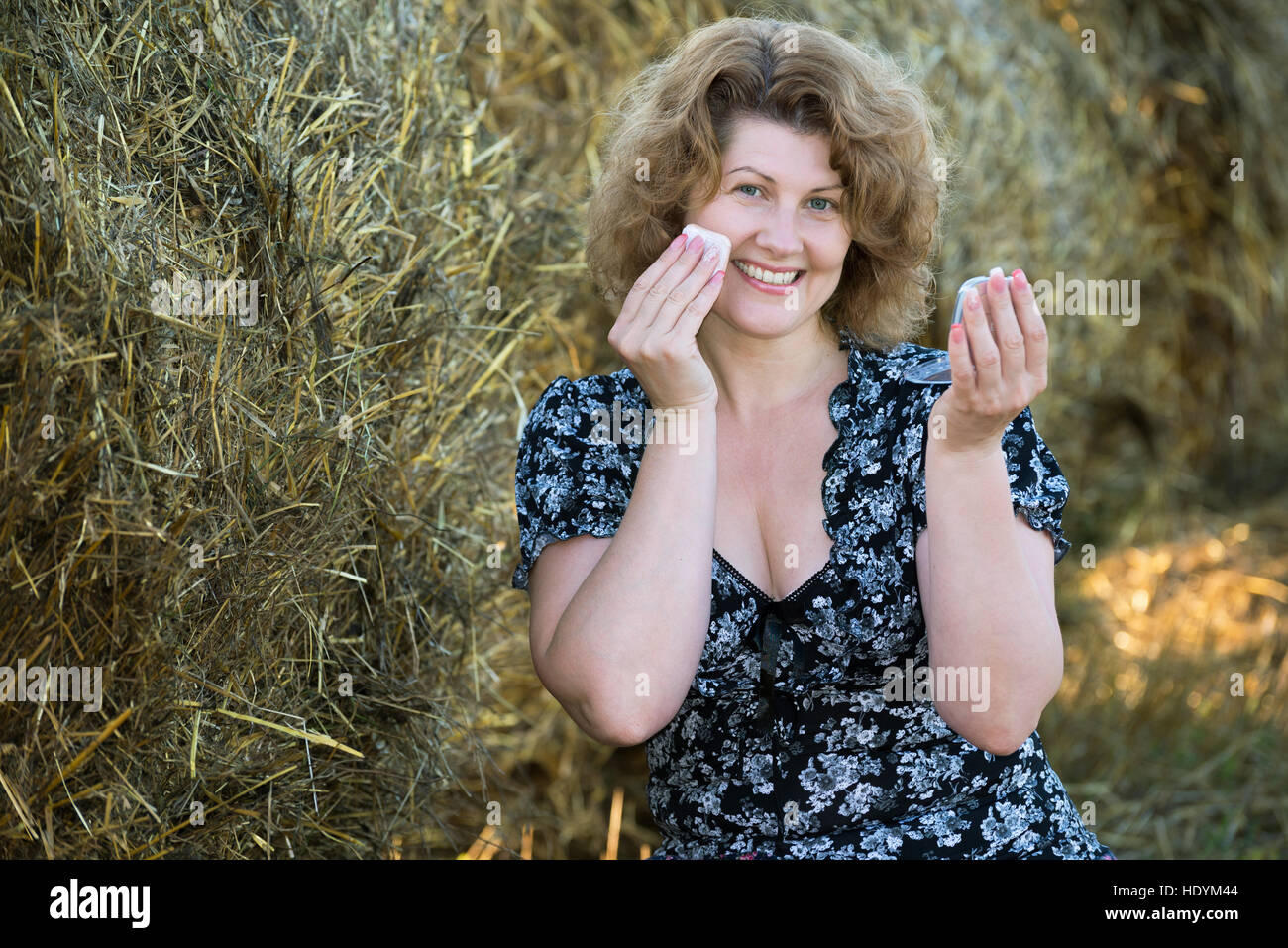Frau Pulver selbst im Feld auf einem Hintergrund von Strohballen Stockfoto