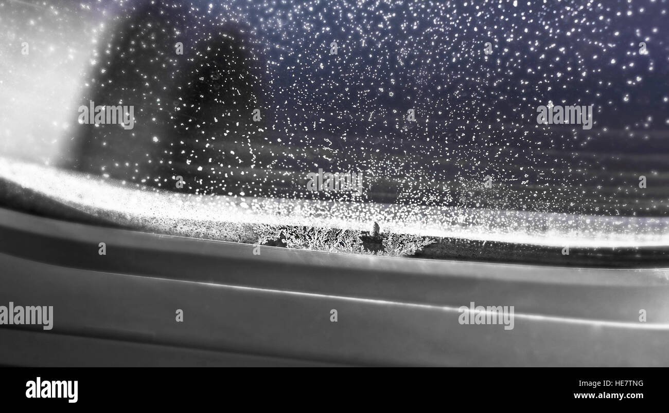 Eis und Schneeflocken im Fenster des Flugzeugs Stockfoto