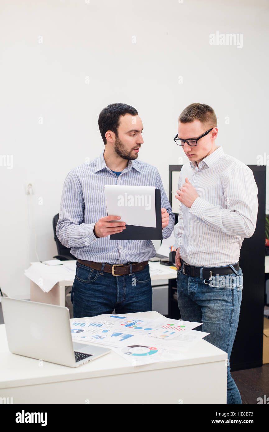 Zwei fröhliche Webdesigner stehen im Büro Stockfoto