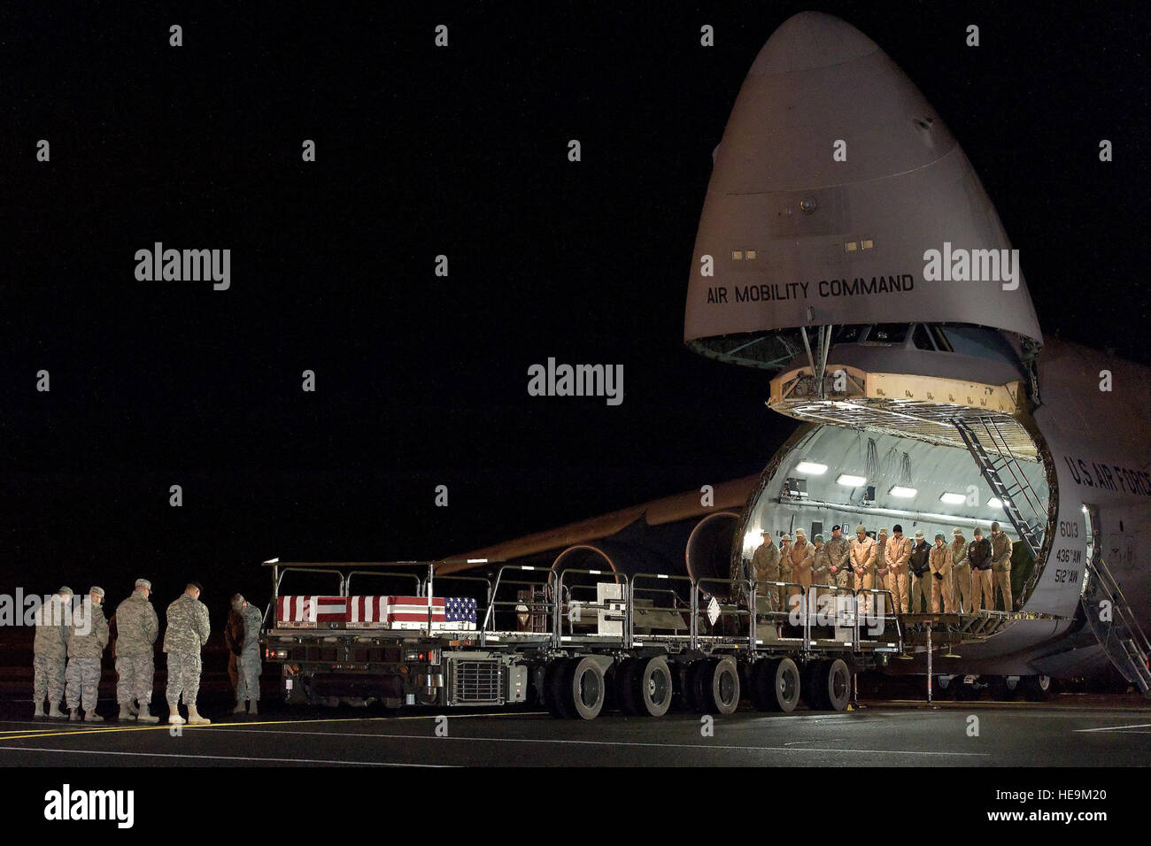 Eine C - 5M Super Galaxy 436th Luftbrücke Flügel zugeordnet, transportiert die Überreste von zwei gefallenen Service-Mitglieder auf der Dover Air Force Base, Del., 26. November 2014. Militärische Mitglieder beugen ihre Köpfe auf die vorwärts Laderampe der Super Galaxie zu Jahresbeginn eine würdige Übertragung wie ein Gebet gelesen wird. In seltenen Fällen bleibt der gefallenen Dienst kommen Mitglieder in Dover AFB auf c-5 Flugzeuge vor dem Transport zur Air Force Leichenhalle Angelegenheiten Operationen. Roland Balik) Stockfoto