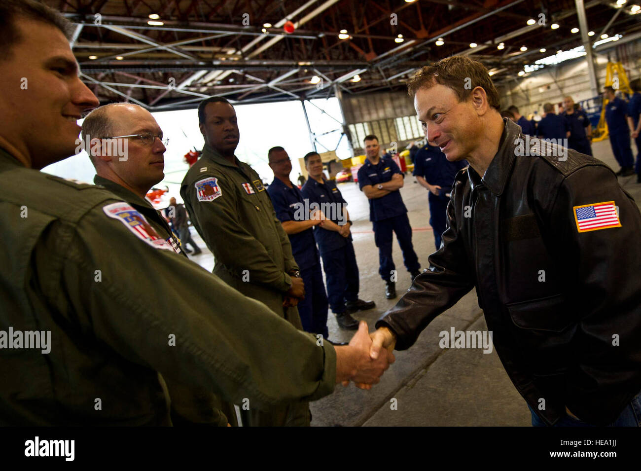 Gary Sinise,(right) Emmy/Golden Globe-Preisträger und Bassist für die Lt. Dan Band schüttelt Hände mit US Coast Guard Pilot Lt. Mark Heussner, 25. Juni 2012 bei Coast Guard Air Station Kodiak, Alaska. Sinise und Lt. Dan Band sind in Alaska auf drei Stop Tour durchzuführen für militärischen Service-Mitglieder und ihre Familien die Lt. Dan Band zahlreiche Konzerte auf der ganzen Welt zu unterstützen, Mitglieder des US-Militär durchgeführt haben. (US Air Force Tech Sgt. Michael R. Holzworth Stockfoto