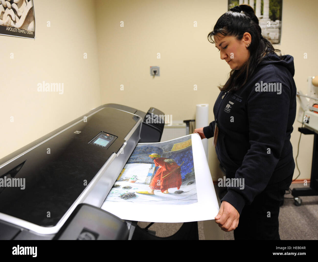 Fatma Yoksuloglu, 39. Kraft Support Squadron handelnden Marketingleiter, druckt ein Leinwand-Poster 29. Februar 2012, auf der Incirlik Air Base, Türkei. Das Marketingbüro erstellt und druckt Poster, Broschüren und Sonstiges Schaufenster für die Incirlik Gemeinschaft. Marketing auch 39. FSS-Website, Blog und Facebook-Seite läuft, verkauft Werbung und base Veranstaltungen fördert.  Senior Airman Anthony Sanchelli Stockfoto