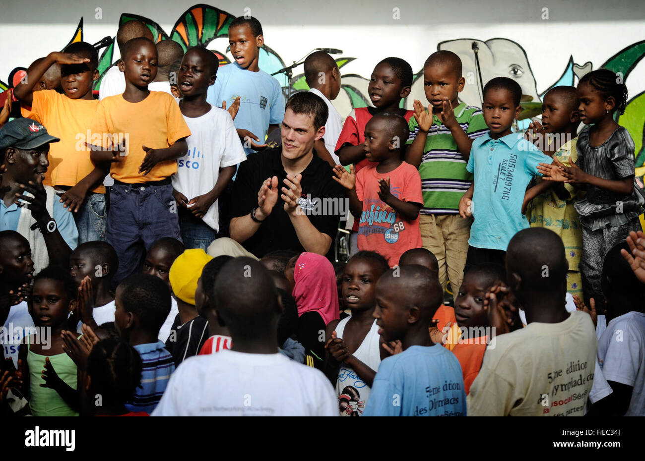 Senior Airman Mike Mitchell, US Air Forces in Europa und Afrika Air Forces Rock Band Keyboarder, singt mit Kindern während eines Konzerts in einem Waisenhaus in Dakar, Senegal 18. Juni 2014. USAFE-AFAFRICA Flieger sind im Senegal für afrikanische Partnerschaft Flug, ein Programm zur Verbesserung der Kommunikation und Interoperabilty zwischen den regionalen Partnern in Afrika. Die Band spielt mehrere Locations in der Umgebung, Kindern und Musikern durch die universelle Sprache der Musik zu begeistern. (Foto der US Air Force / Staff Sgt Ryan Crane) Stockfoto