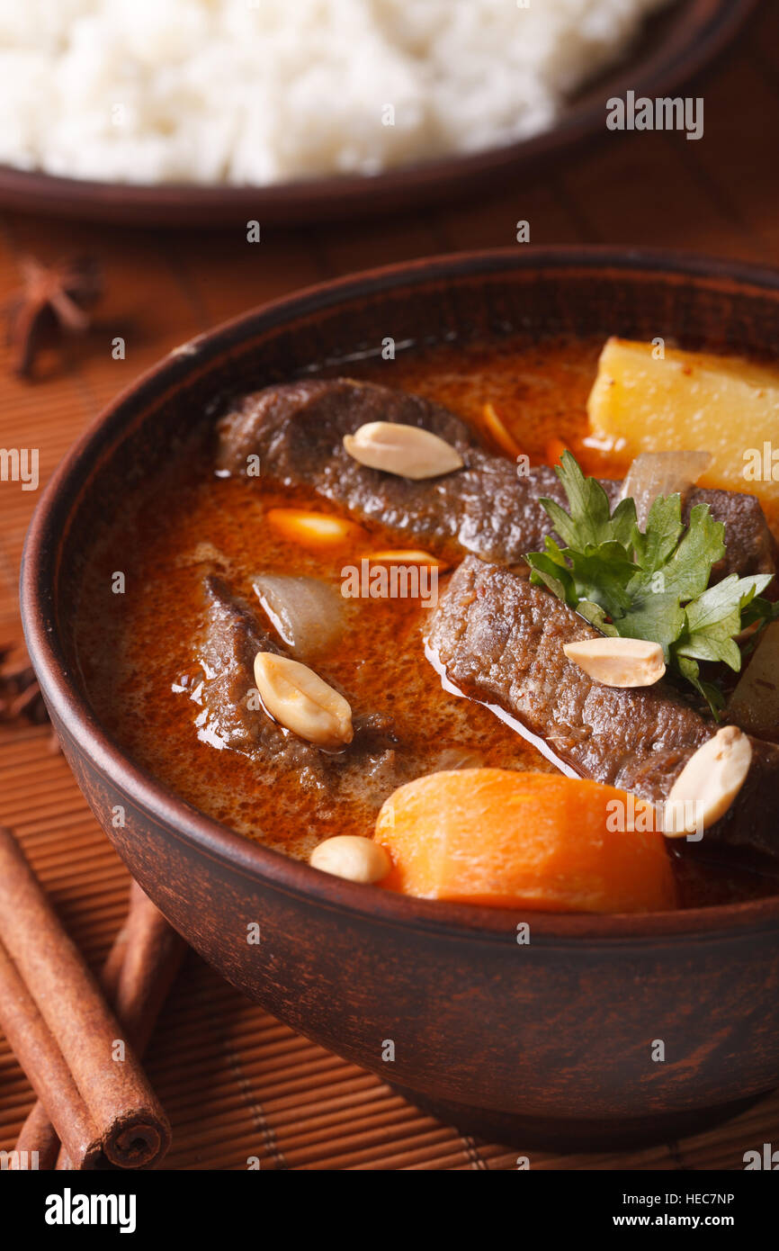 Thailändischen Massaman curry mit Rindfleisch und Erdnüsse auf den Tisch-Makro. vertikale Stockfoto