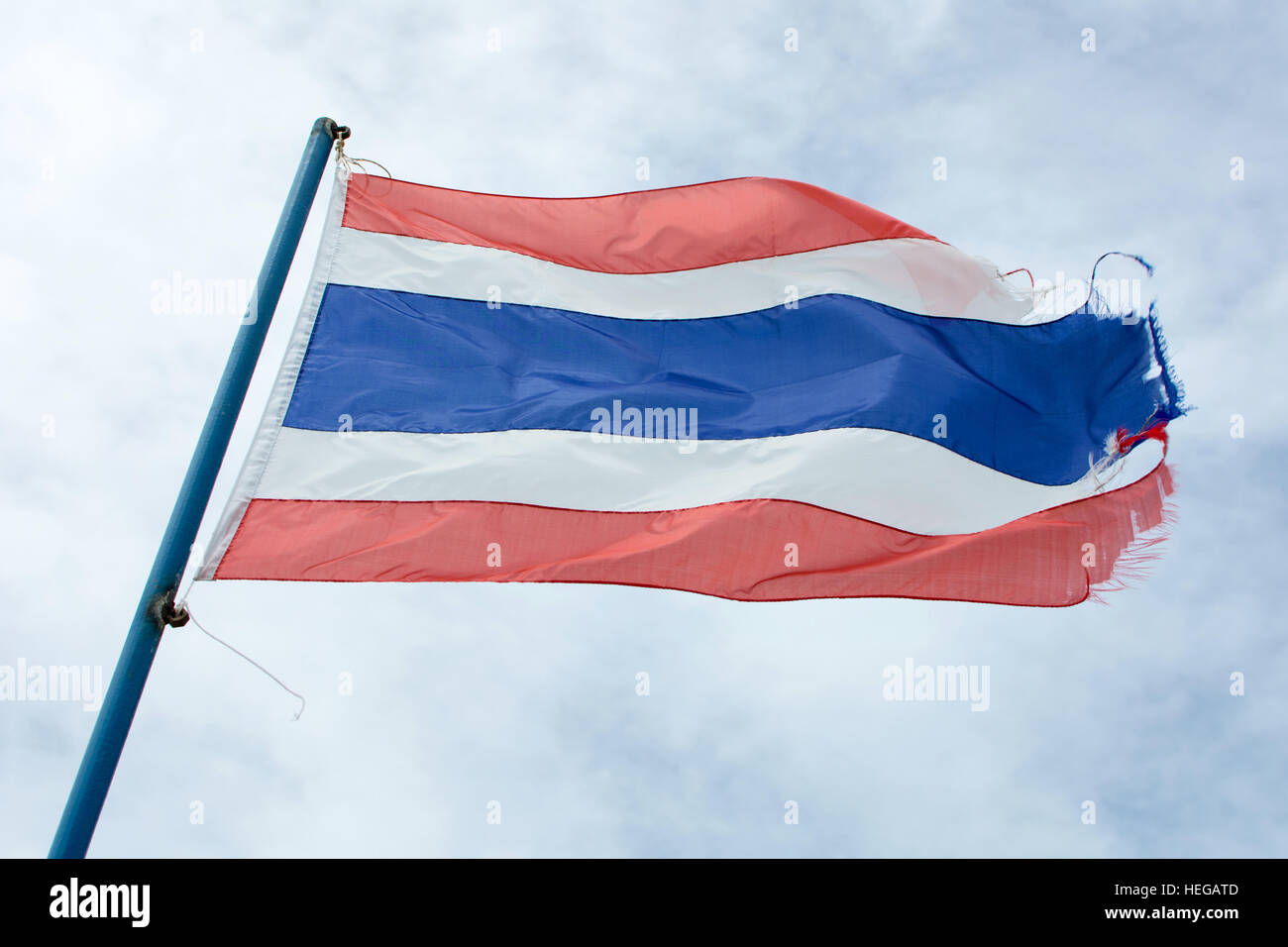 Wellig alte Flagge des Königreichs Thailand gegen blauen Himmel Stockfoto