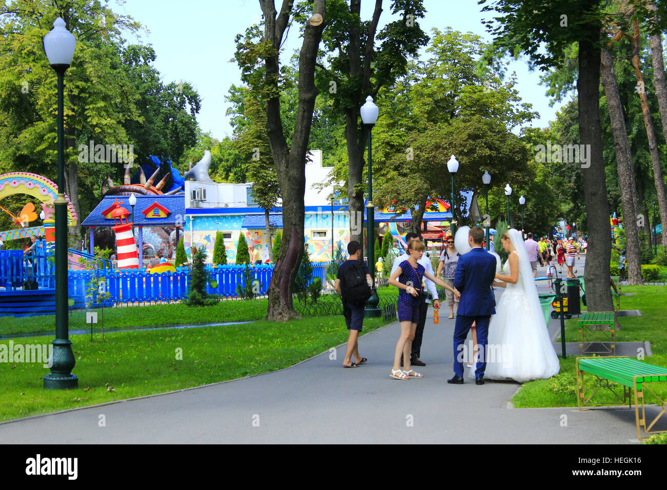 Ehepaar mit Freunden spazieren im Stadtpark Horkyi mit großen Bäumen in Charkow. 7. August 2016 in Charkow. Stockfoto