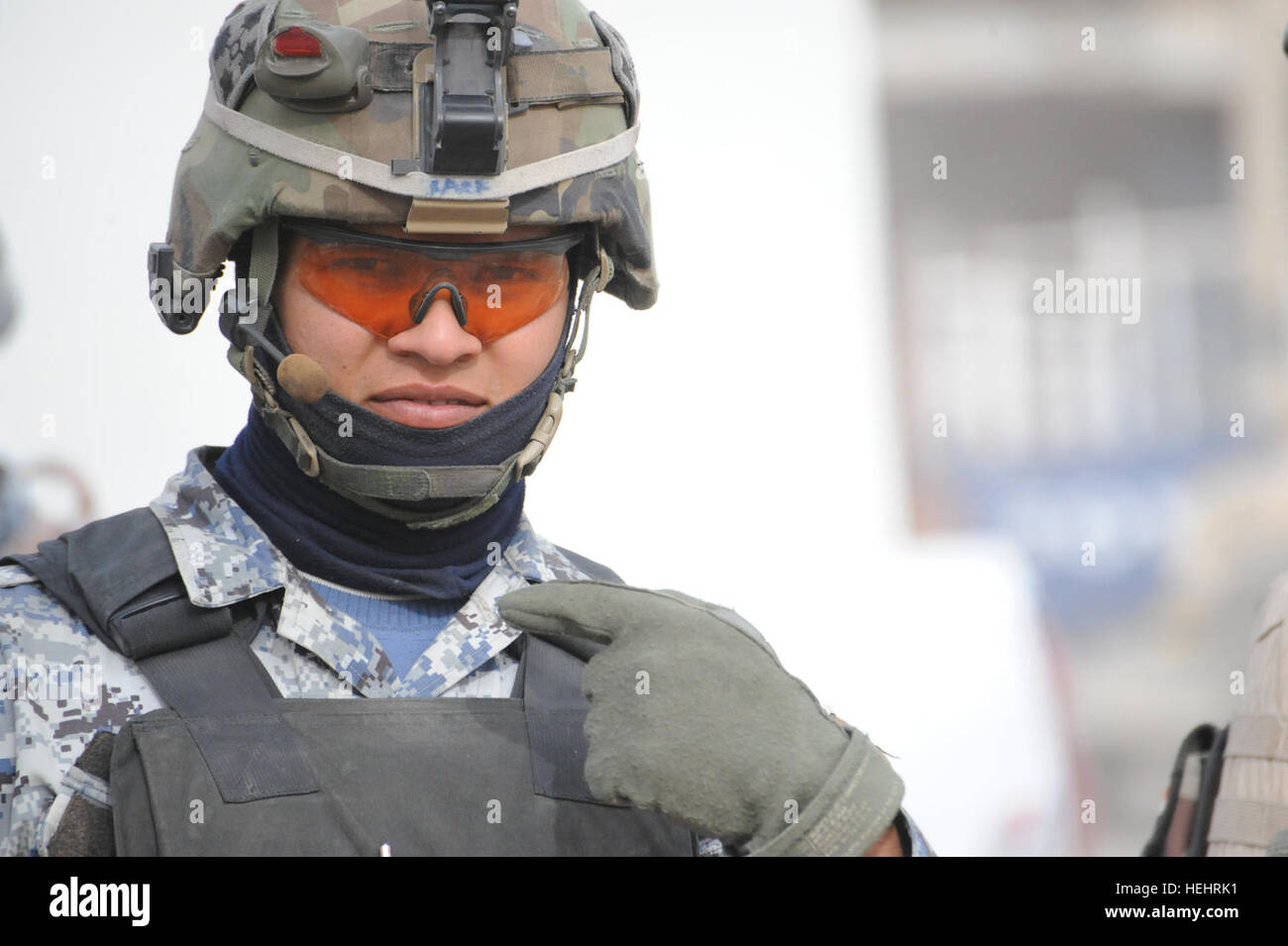 Eine irakische nationale Polizist Gesten, die er will, sein Foto, außerhalb einer Schule in Shawra Wa Umm Cıdır östlichen Bagdad, Irak, am 8. März. Irakische Nationalpolizei und US-Soldaten der Bravo Company, 2. Bataillon, 505. Fallschirm-Infanterie-Regiment, 3rd Brigade Combat Team, 82nd Airborne Division, besuchen Schulen und Lieferungen zu verteilen. Soldaten, irakische nationale Polizisten verteilen Schulmaterial in Bagdad 157246 Stockfoto